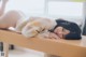 A woman laying on top of a wooden table.