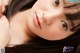 A close up of a woman with long black hair.