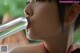 A young girl drinking water from a plastic bottle.