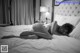 A woman laying on top of a bed in a bedroom.