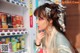 A woman standing in front of a vending machine.