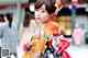 A young girl in a colorful kimono is walking down the street.