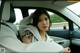 A woman sitting in the back seat of a car.